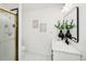 Updated bathroom features a sleek vanity, black hardware, and a shower with glass door at 6463 S Vance St, Littleton, CO 80123