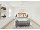 Bright bedroom with stylish decor, a wooden headboard, and a gray bench at 6463 S Vance St, Littleton, CO 80123