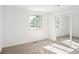 Bright bedroom featuring large window, plush carpeting, and mirrored closet at 6463 S Vance St, Littleton, CO 80123