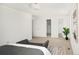Bright bedroom with neutral carpet, white walls, and ensuite bathroom entries at 6463 S Vance St, Littleton, CO 80123