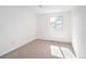 Well-lit bedroom with plush carpet, white walls, and a window for natural light at 6463 S Vance St, Littleton, CO 80123