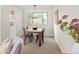 Cozy dining room features a wooden table and black chairs near a window with natural lighting and neutral paint at 6463 S Vance St, Littleton, CO 80123