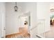 Inviting foyer with a pendant light, wood floors, and a staircase leading to the upper level at 6463 S Vance St, Littleton, CO 80123
