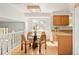 Bright eat-in kitchen includes wooden cabinets, granite countertops, and modern fixtures, illuminated by a window at 6463 S Vance St, Littleton, CO 80123