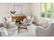 Living room with comfortable seating, stylish decor, a coffee table centerpiece, and a large bright window at 6463 S Vance St, Littleton, CO 80123
