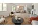 Spacious living room with neutral tones, cozy seating, and access to an outdoor space at 6463 S Vance St, Littleton, CO 80123