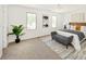 Bright main bedroom with natural light, carpet floors, modern decor, and a comfortable seating area at 6463 S Vance St, Littleton, CO 80123