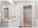 Bathroom featuring double sink vanity, large mirror and walk-in closet at 48255 Shetland Dr, Bennett, CO 80102