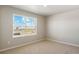 Comfortable bedroom featuring neutral carpet, large windows providing ample light and fresh paint at 48255 Shetland Dr, Bennett, CO 80102