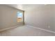 This bedroom has neutral carpeting and a window allowing natural light to illuminate the interior at 48255 Shetland Dr, Bennett, CO 80102