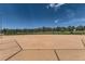 View of an empty baseball diamond with an outfield fence and tree line under a sunny sky at 907 W Beverly St, Elizabeth, CO 80107