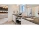 Bathroom featuring double sinks, vanity, and a decorative mirror next to a window and glass shower doors at 907 W Beverly St, Elizabeth, CO 80107