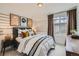 Stylish bedroom featuring striped walls, a modern bed, and soft lighting for a relaxing ambiance at 907 W Beverly St, Elizabeth, CO 80107