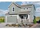 Charming two-story home featuring a gray exterior, a two-car garage and a welcoming front porch at 907 W Beverly St, Elizabeth, CO 80107