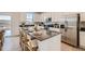 Bright kitchen with island seating, stainless steel appliances, and modern white cabinets at 907 W Beverly St, Elizabeth, CO 80107