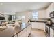 Modern kitchen featuring sleek white cabinets, stainless steel appliances, and a large island perfect for cooking at 907 W Beverly St, Elizabeth, CO 80107