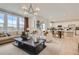 Spacious living room and kitchen showcasing an open-concept layout, stylish furnishings, and lots of natural light at 907 W Beverly St, Elizabeth, CO 80107