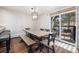 Inviting dining area features a rustic table and chairs, and access to a patio with outdoor seating at 107 N Harris St # 102, Breckenridge, CO 80424