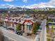 Exterior view of condo building showcasing street view, nearby parking, and serene mountain backdrop at 107 N Harris St # 102, Breckenridge, CO 80424