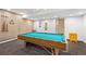 Condo game room featuring pool table, natural wood paneled walls, and neutral carpet at 107 N Harris St # 102, Breckenridge, CO 80424