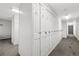 Hallway view with long row of white storage lockers against the wall in a condo building at 107 N Harris St # 102, Breckenridge, CO 80424