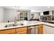 Modern kitchen with stainless dishwasher, sleek counters and view to the living room at 107 N Harris St # 102, Breckenridge, CO 80424
