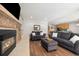 Spacious living room open to kitchen with sofas, stone fireplace, and wood floors at 107 N Harris St # 102, Breckenridge, CO 80424