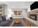 Bright living room featuring a stone fireplace and a window bench seat at 107 N Harris St # 102, Breckenridge, CO 80424