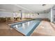 Indoor pool area with a hot tub, tables and chairs, and large windows at 107 N Harris St # 102, Breckenridge, CO 80424