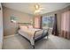 Bedroom with neutral paint, ceiling fan, large window and carpeted floors at 925 Antelope W Dr, Bennett, CO 80102