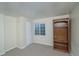 Finished basement area with carpet and a built-in bookshelf and window at 87 Macon Ct, Aurora, CO 80010