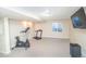 Finished basement area with carpet flooring, workout equipment, and TV at 87 Macon Ct, Aurora, CO 80010