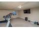 Finished basement has workout equipment, tv, and bright lighting at 87 Macon Ct, Aurora, CO 80010