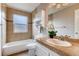 Bathroom featuring tiled walls, granite countertop, and updated fixtures at 87 Macon Ct, Aurora, CO 80010
