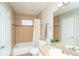 Bathroom with neutral tile, modern fixtures, and bathtub at 87 Macon Ct, Aurora, CO 80010