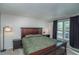 Serene bedroom featuring a king bed, bedside tables, and natural light from the window at 87 Macon Ct, Aurora, CO 80010