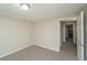 Neutral carpeted bedroom features a closet and adjacent entry way at 87 Macon Ct, Aurora, CO 80010