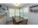 Bright dining space with natural light, wood table and chairs, and views of the backyard at 87 Macon Ct, Aurora, CO 80010