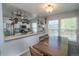 Eat-in kitchen space with a wooden dining table and chairs near the kitchen area at 87 Macon Ct, Aurora, CO 80010
