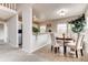 Dining room features tile flooring, a plant, and easy access to kitchen and staircase at 87 Macon Ct, Aurora, CO 80010