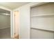 Hallway with carpet flooring and closet with built-in shelves at 87 Macon Ct, Aurora, CO 80010