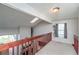 Bright hallway features skylight, natural lighting, and updated railing at 87 Macon Ct, Aurora, CO 80010