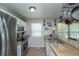 Efficient kitchen with stainless steel appliances, bar seating, and ample counter space at 87 Macon Ct, Aurora, CO 80010