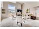 Bright living room with fireplace, vaulted ceilings, and sliding glass doors for natural light at 87 Macon Ct, Aurora, CO 80010