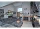 Inviting living room featuring a fireplace, plush gray sectional, and vaulted ceilings at 87 Macon Ct, Aurora, CO 80010