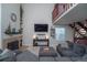 Comfortable living room with a fireplace, large TV, and a cozy gray sectional at 87 Macon Ct, Aurora, CO 80010