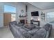 Open living space with large sectional, fireplace, and sliding door access to the outdoors at 87 Macon Ct, Aurora, CO 80010