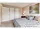 Comfortable main bedroom features neutral tones, a painting and ample closet space for storage at 87 Macon Ct, Aurora, CO 80010