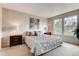 Serene main bedroom with plush carpet, and dual windows providing plenty of natural light and outdoor views at 87 Macon Ct, Aurora, CO 80010