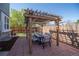 Charming outdoor patio with a pergola, dining table, cushioned chairs, and brick flooring for relaxed gatherings at 87 Macon Ct, Aurora, CO 80010